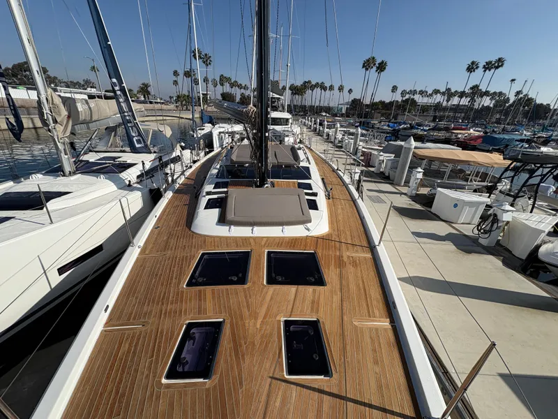 Slide: The Image of Dufour 560 Exclusive 2018 yacht docked, showcasing sleek deck design and marina backdrop. - 17