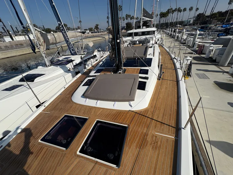 Slide: The Image of 2018 Dufour 560 Exclusive yacht with teak deck, docked at marina. - 19