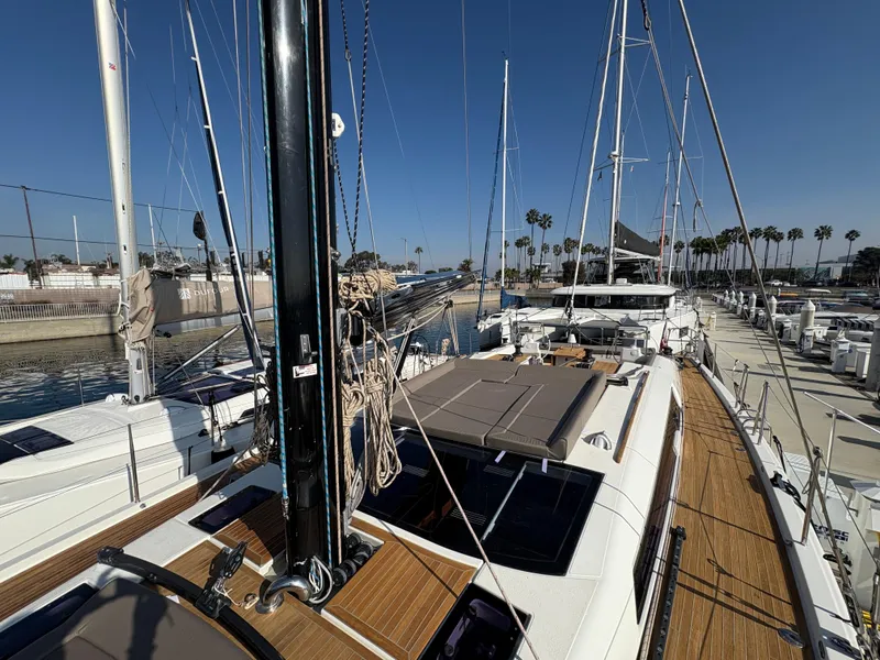 Slide: The Image of 2018 Dufour 560 Exclusive yacht docked, showcasing sleek design and spacious deck. - 22