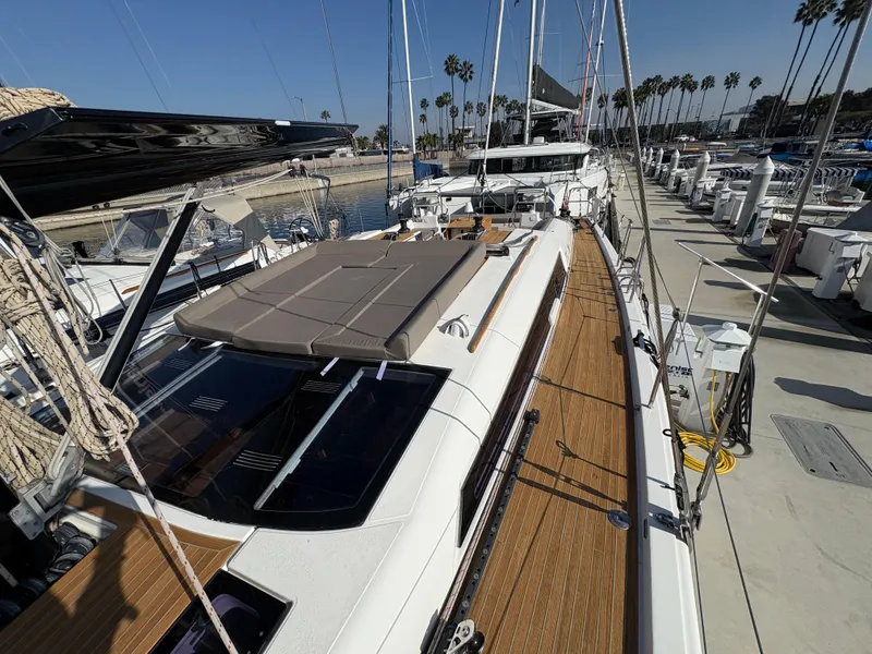 Slide: The Image of Dufour 560 Exclusive 2018 yacht docked, showcasing sleek design and spacious deck. - 23