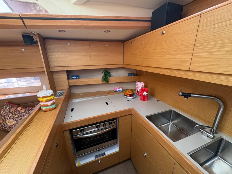 Slide: The Image of Modern kitchen interior of 2018 Dufour 560 Exclusive yacht with wooden cabinetry and stainless steel sink. - 36