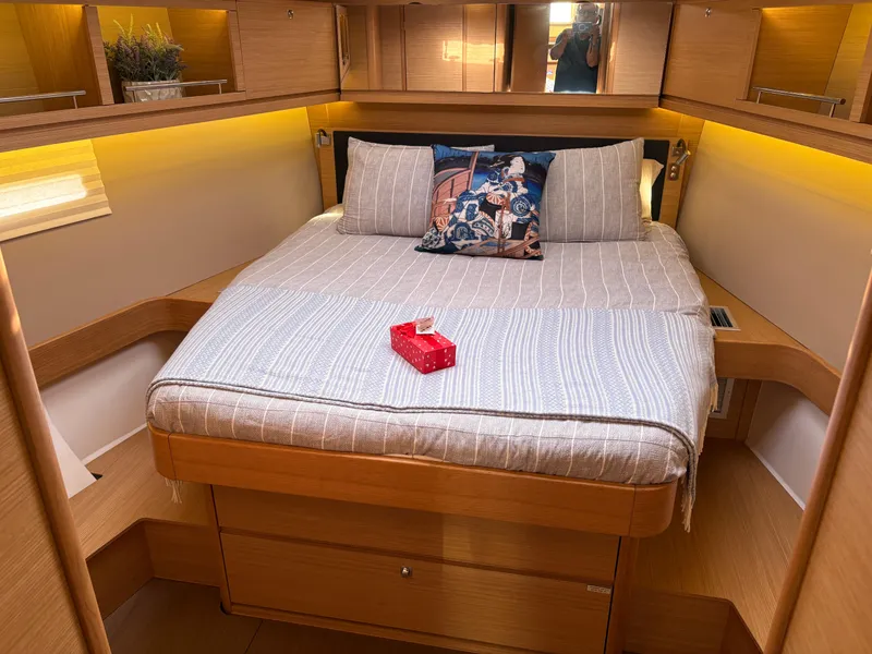 Slide: The Image of Cozy bedroom in 2018 Dufour 560 Exclusive yacht with elegant bedding and ambient lighting. - 38