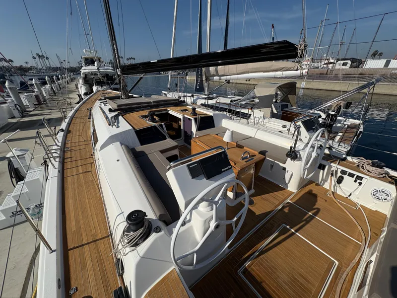 Slide: The Image of Luxury 2018 Dufour 560 Exclusive yacht with spacious deck and dual steering wheels in marina. - 4