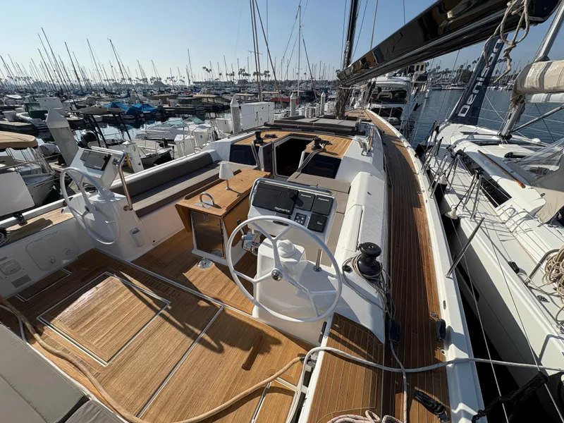 Slide: The Image of Dufour 560 Exclusive 2018 yacht with dual steering wheels and teak deck in marina. - 5