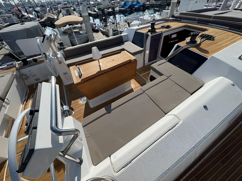 Slide: The Image of Dufour 560 Exclusive 2018 yacht deck with seating and helm, docked at marina. - 9