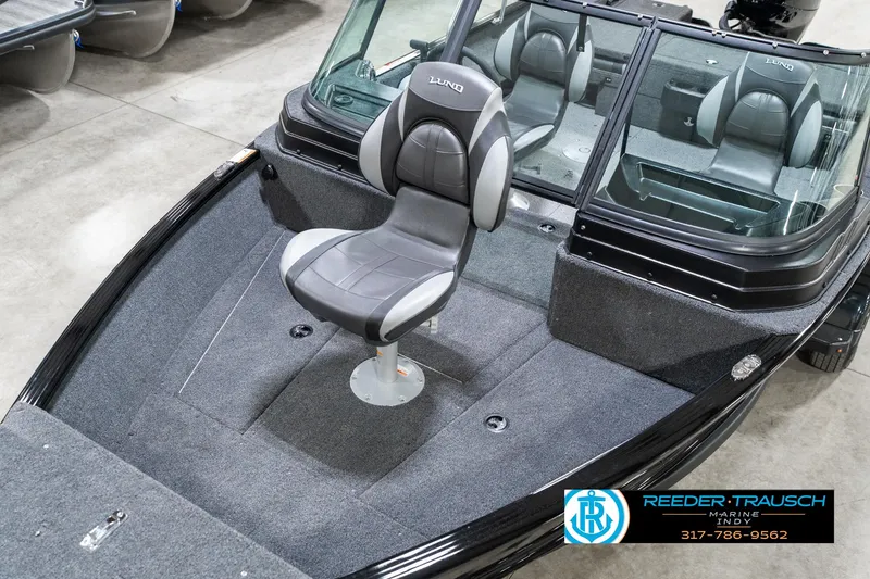 Slide: The Image of 2025 Lund 1775 Adventure Sport boat with swivel seat, showcased indoors. - 11