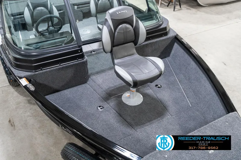 Slide: The Image of 2025 Lund 1775 Adventure Sport boat interior with swivel seat, gray upholstery, and windshield. - 12