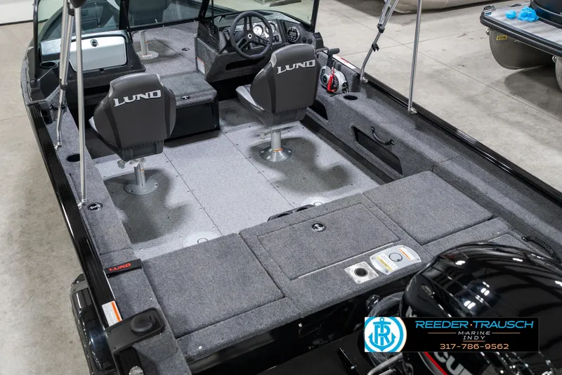 Slide: The Image of 2025 Lund 1775 Adventure Sport boat interior with seating and steering console. - 14