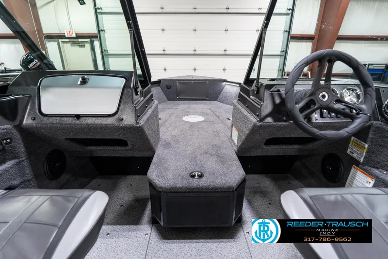 Slide: The Image of 2025 Lund 1775 Adventure Sport boat interior with steering wheel and seating. - 16