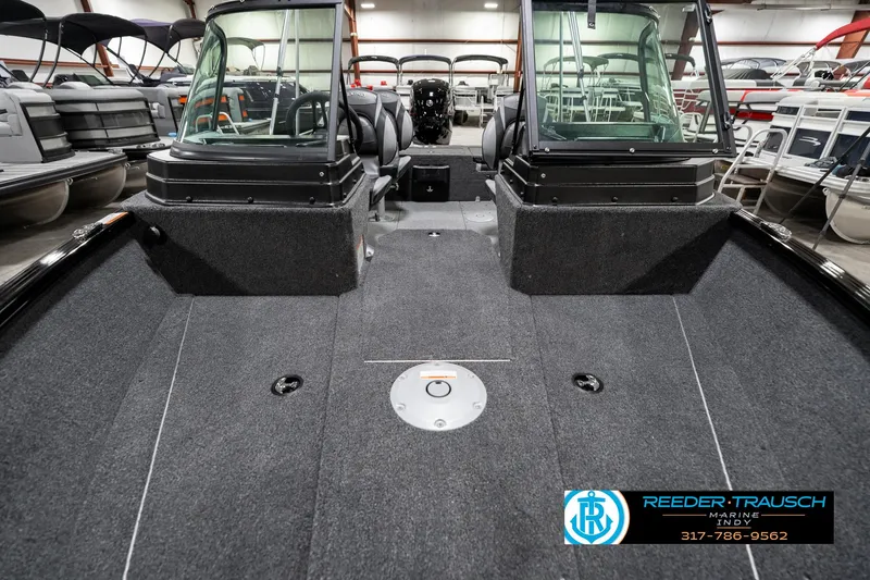 Slide: The Image of 2025 Lund 1775 Adventure Sport boat interior with dual consoles and spacious deck. - 18