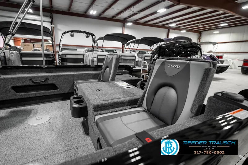 Slide: The Image of 2025 Lund 1775 Adventure Sport boat interior with gray seating in showroom. - 26
