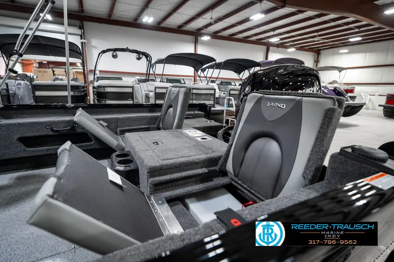 Slide: The Image of 2025 Lund 1775 Adventure Sport boat interior with seating and storage in showroom. - 27