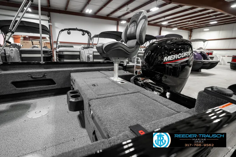 Slide: The Image of 2025 Lund 1775 Adventure Sport boat interior with Mercury engine in showroom. - 28