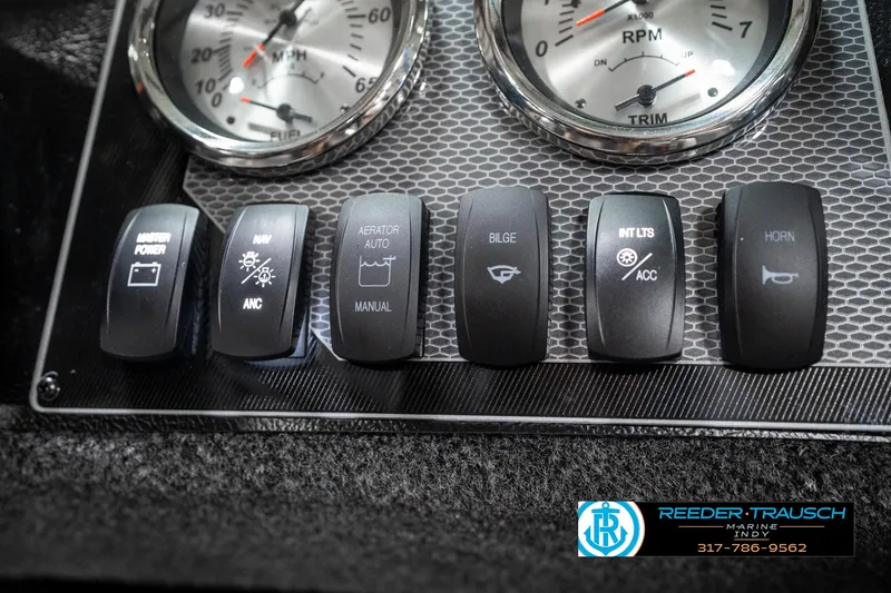 Slide: The Image of Control panel of 2025 Lund 1775 Adventure Sport boat with various switches and gauges. - 37