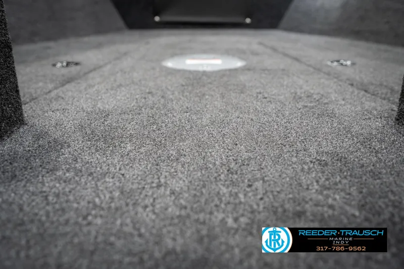 Slide: The Image of 2025 Lund 1775 Adventure Sport boat interior with carpeted flooring, Reeder-Trausch logo visible. - 48