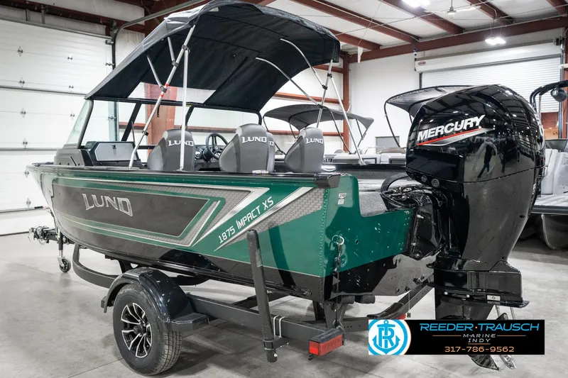 Slide: The Image of 2025 Lund 1875 Impact XS boat with Mercury engine in showroom. - 10
