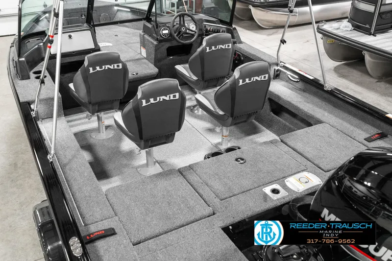 Slide: The Image of 2025 Lund 1875 Impact XS boat interior with four seats and steering console. - 15