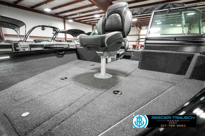 Slide: The Image of 2025 Lund 1875 Impact XS boat interior with swivel seat in showroom. - 24