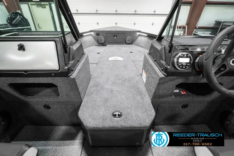 Slide: The Image of 2025 Lund 1875 Impact XS boat interior with modern dashboard and spacious seating. - 31