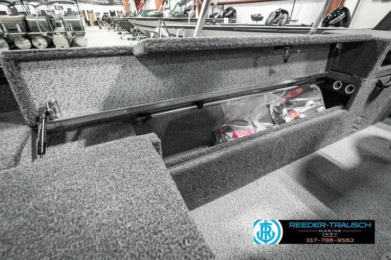 Slide: The Image of 2025 Lund 1875 Impact XS boat interior storage compartment with carpeted finish. - 36