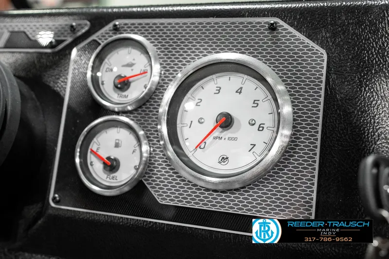 Slide: The Image of Dashboard gauges of 2025 Lund 1875 Impact XS boat, featuring RPM, trim, and fuel indicators. - 41