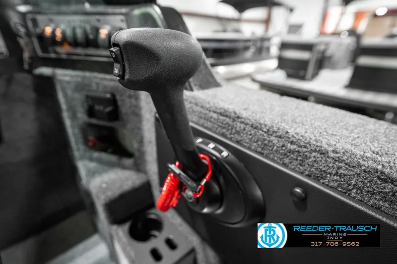 Slide: The Image of 2025 Lund 1875 Impact XS boat throttle control with red safety lanyard. - 43