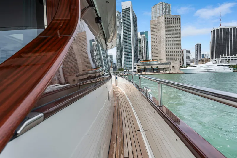Slide: The Image of Steeler 60 S Performance yacht, 2021, cruising near city skyline and waterfront buildings. - 23