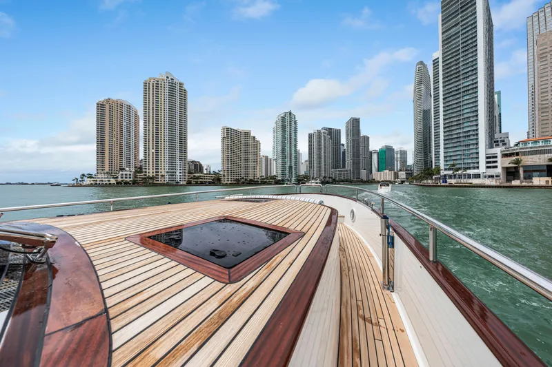 Slide: The Image of Luxury Steeler 60 S Performance yacht cruising near city skyline, 2021 model. - 24