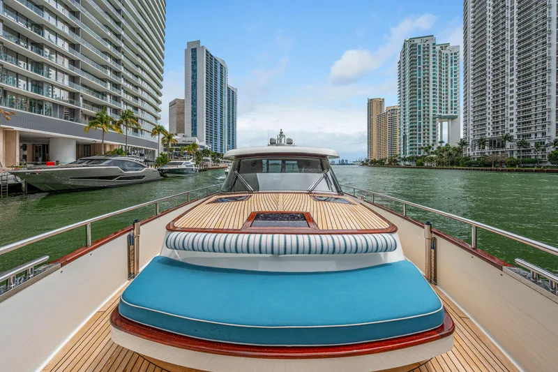 Slide: The Image of 2021 Steeler 60 S Performance yacht cruising in urban waterway with skyscrapers. - 27