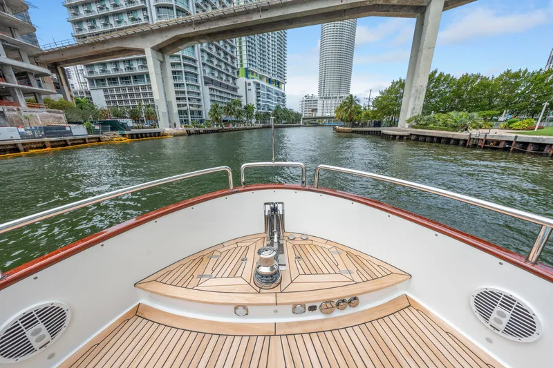 Slide: The Image of Bow view of 2021 Steeler 60 S Performance yacht navigating urban waterway. - 31