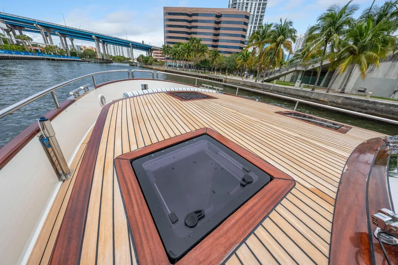 Slide: The Image of Steeler 60 S Performance 2021 yacht deck with sleek wood finish, docked by palm trees. - 32