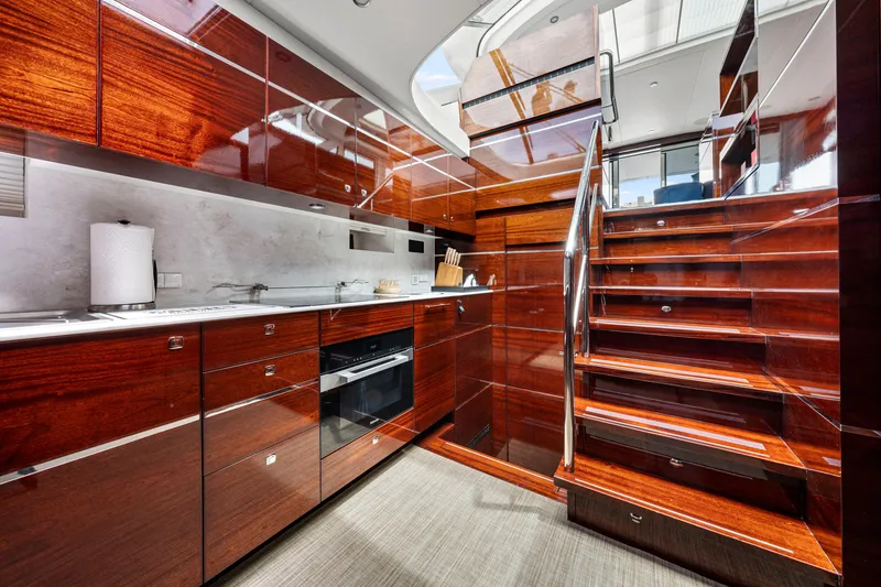 Slide: The Image of Luxurious kitchen interior of 2021 Steeler 60 S Performance yacht with wooden cabinetry and modern appliances. - 39