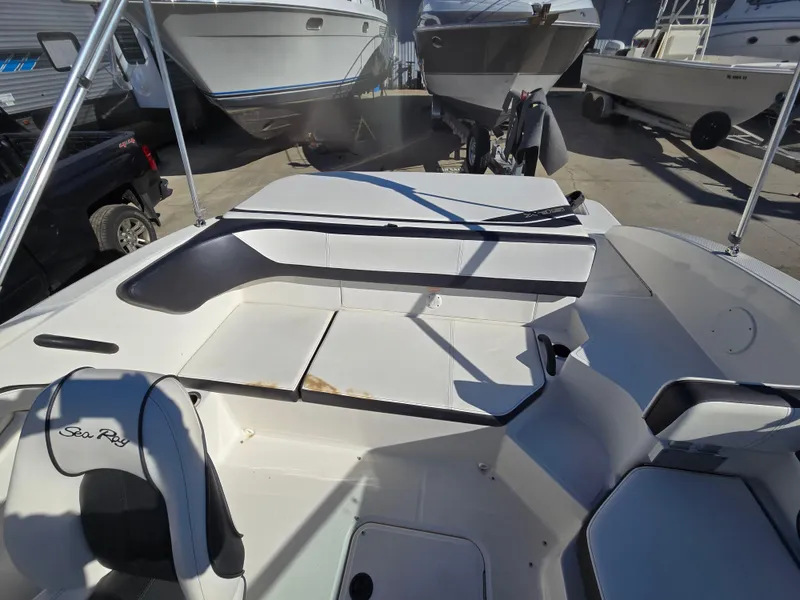 Slide: The Image of 2015 Sea Ray SPX 190 boat interior with seating and storage compartments. - 13