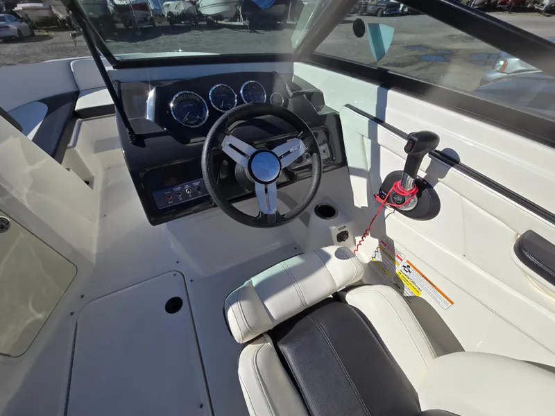 Slide: The Image of 2015 Sea Ray SPX 190 boat interior with steering wheel and dashboard controls. - 14