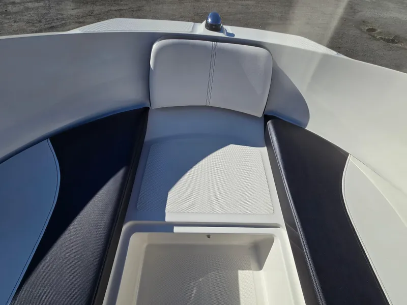Slide: The Image of 2015 Sea Ray SPX 190 boat interior with cushioned seating and storage compartment. - 17