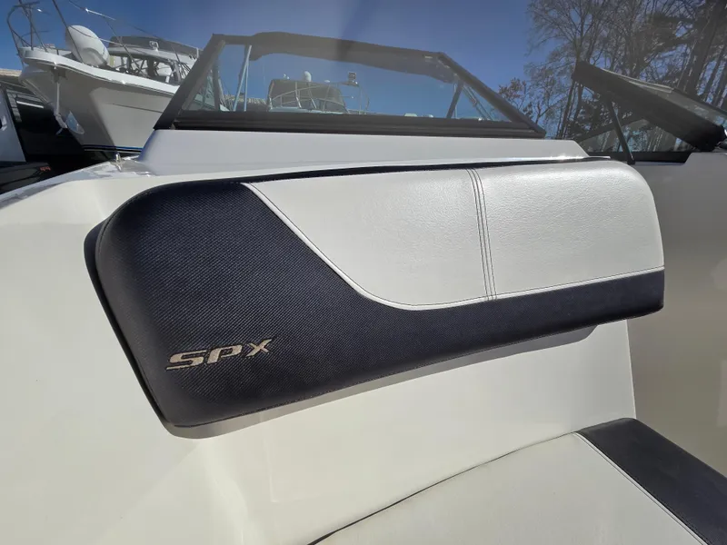 Slide: The Image of 2015 Sea Ray SPX 190 boat interior detail with logo, showcasing sleek design. - 18