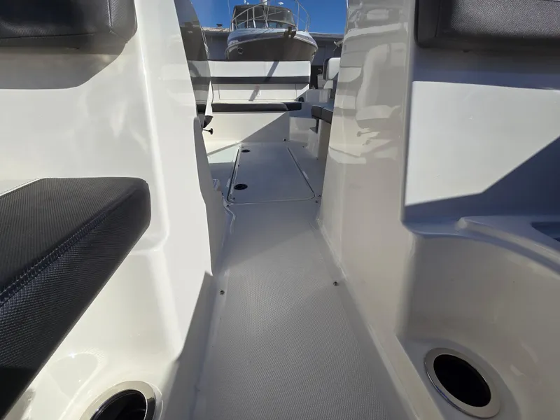 Slide: The Image of 2015 Sea Ray SPX 190 boat interior with seating and storage compartments. - 19