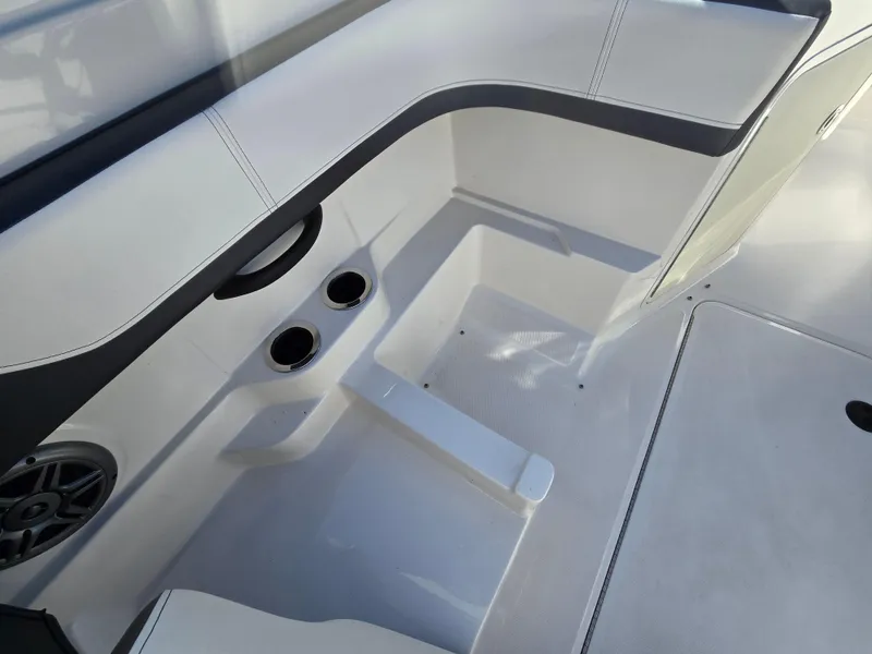 Slide: The Image of 2015 Sea Ray SPX 190 boat interior with cup holders and seating area. - 23