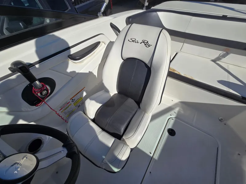 Slide: The Image of 2015 Sea Ray SPX 190 boat interior with steering wheel and branded seat. - 27