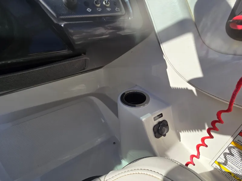 Slide: The Image of Interior of 2015 Sea Ray SPX 190 boat, featuring a cup holder and control panel. - 28