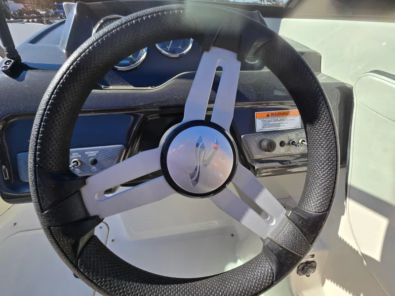 Slide: The Image of Steering wheel of a 2015 Sea Ray SPX 190 boat, featuring a sleek design. - 31