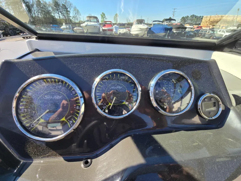 Slide: The Image of Dashboard of a 2015 Sea Ray SPX 190 boat with gauges and controls. - 32