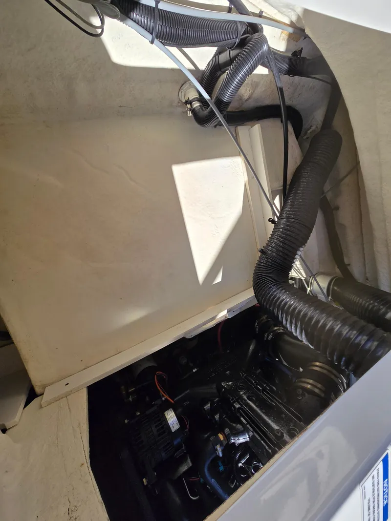 Slide: The Image of Engine compartment of a 2015 Sea Ray SPX 190 boat, showing mechanical components. - 39