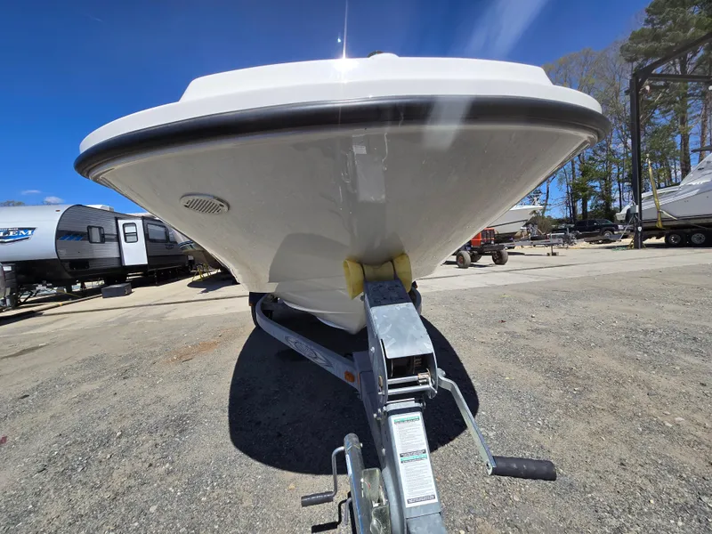 Slide: The Image of 2015 Sea Ray SPX 190 boat on trailer, parked outdoors under clear blue sky. - 5