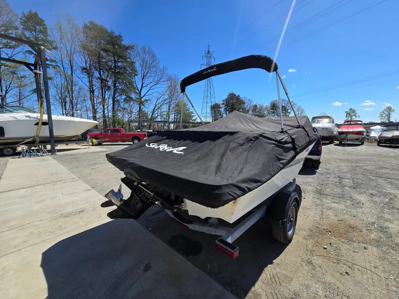 Slide: The Image of 2015 Sea Ray SPX 190 boat with cover on trailer, parked outdoors. - 6