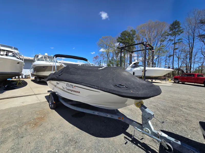 Slide: The Image of 2015 Sea Ray SPX 190 boat on trailer, covered, parked outdoors under clear sky. - 7