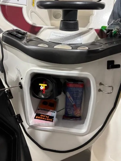 Slide: The Image of 2002 Sea-Doo 180 Challenger dashboard storage with snacks and accessories. - 12