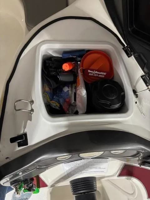 Slide: The Image of Storage compartment of a 2002 Sea-Doo Sport Boats 180 Challenger, containing various boating essentials. - 13