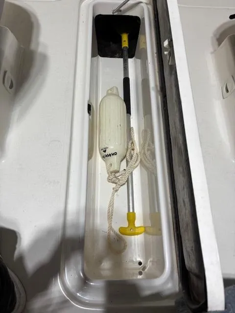 Slide: The Image of Storage compartment in a 2002 Sea-Doo 180 Challenger boat with boating accessories. - 16