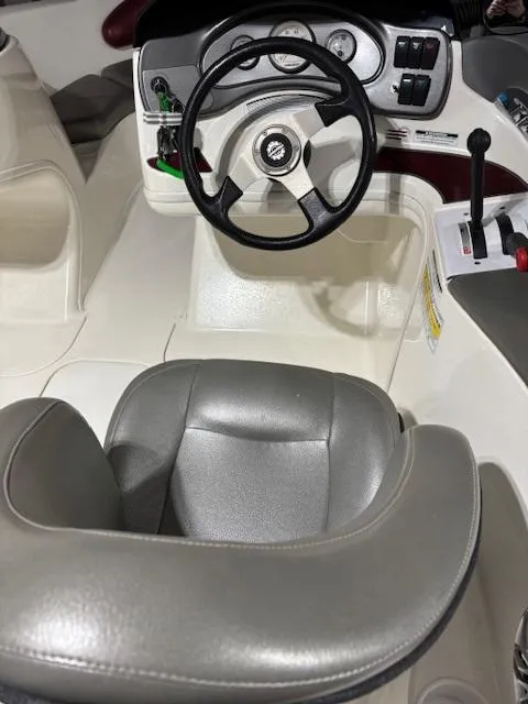 Slide: The Image of 2002 Sea-Doo 180 Challenger boat interior with steering wheel and controls. - 18